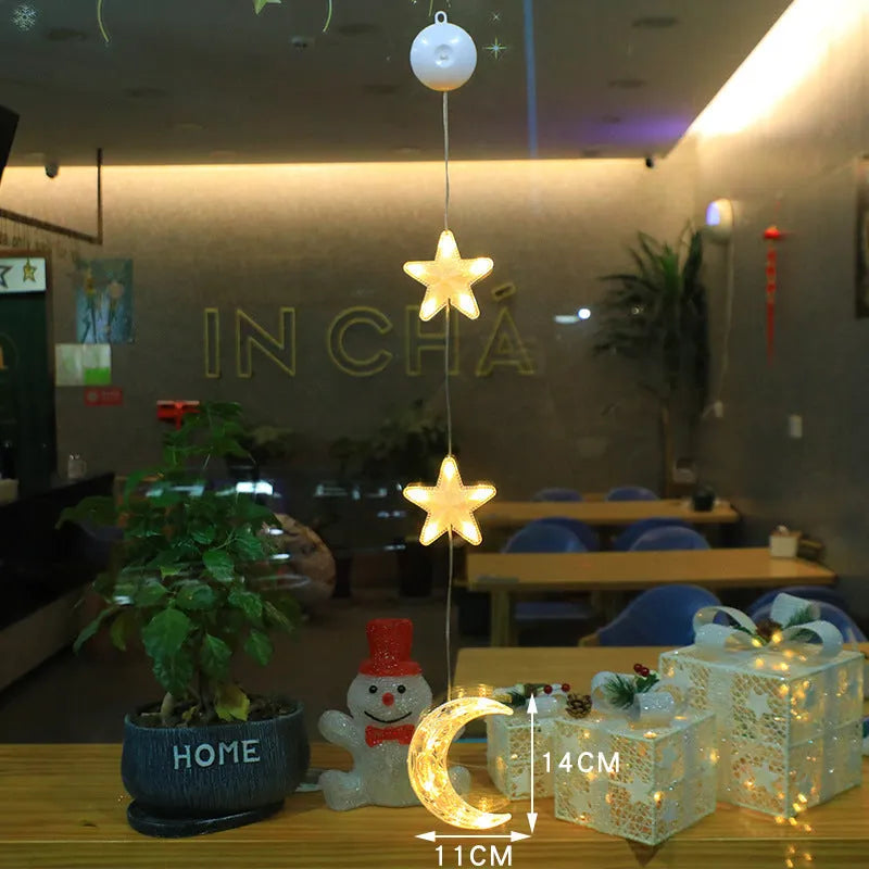 Three Christmas LED light ornaments with suction cups hanging on window