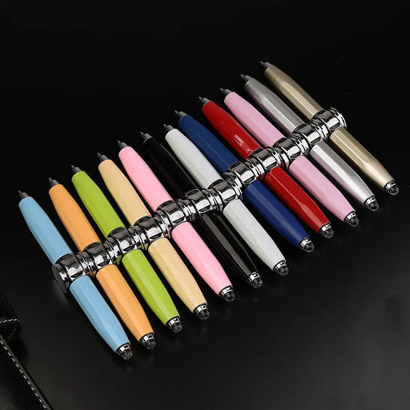 Metal gyro ballpoint pen with LED lights shown spinning, 10.5 cm long.