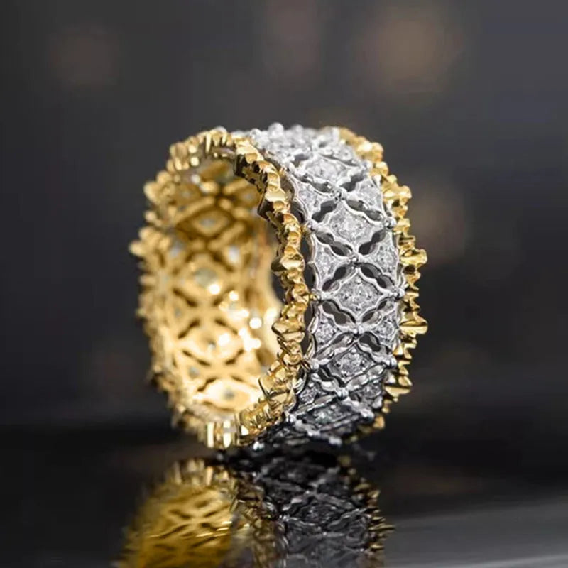 Gold two-tone geometric women's zircon ring on a plain background, showing its round stone and copper construction.