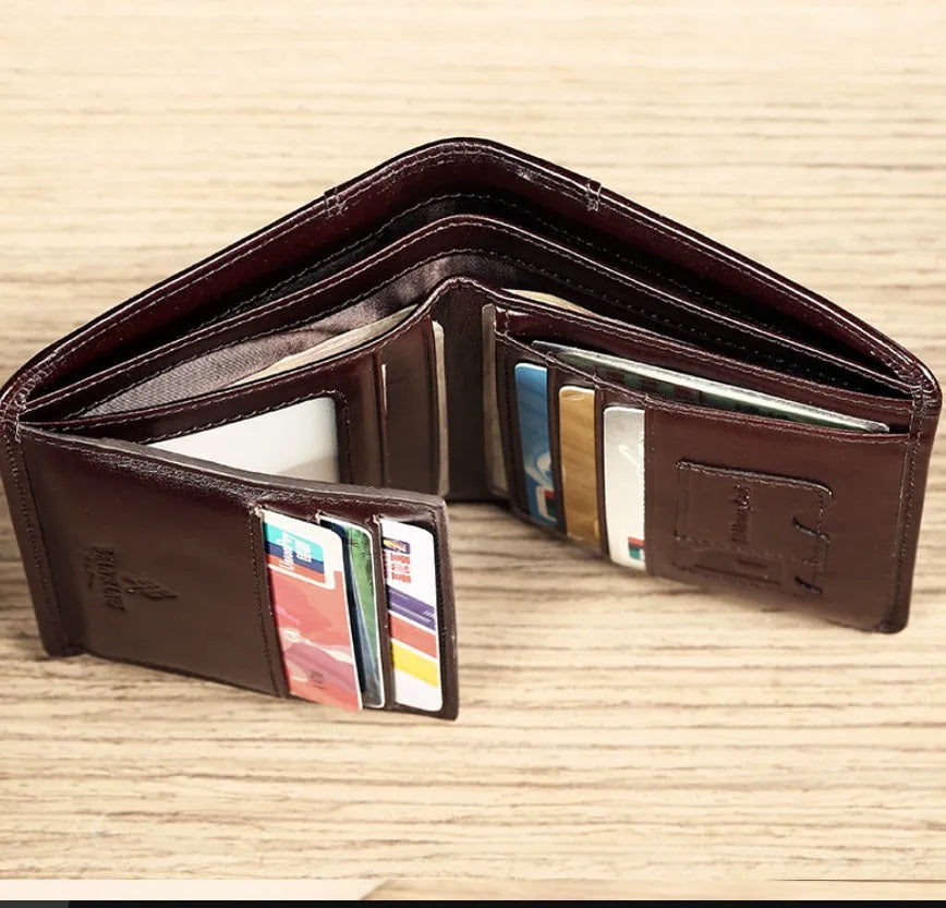 Men's black leather RFID blocking wallet open to show card slots, ID window, and coin pocket.