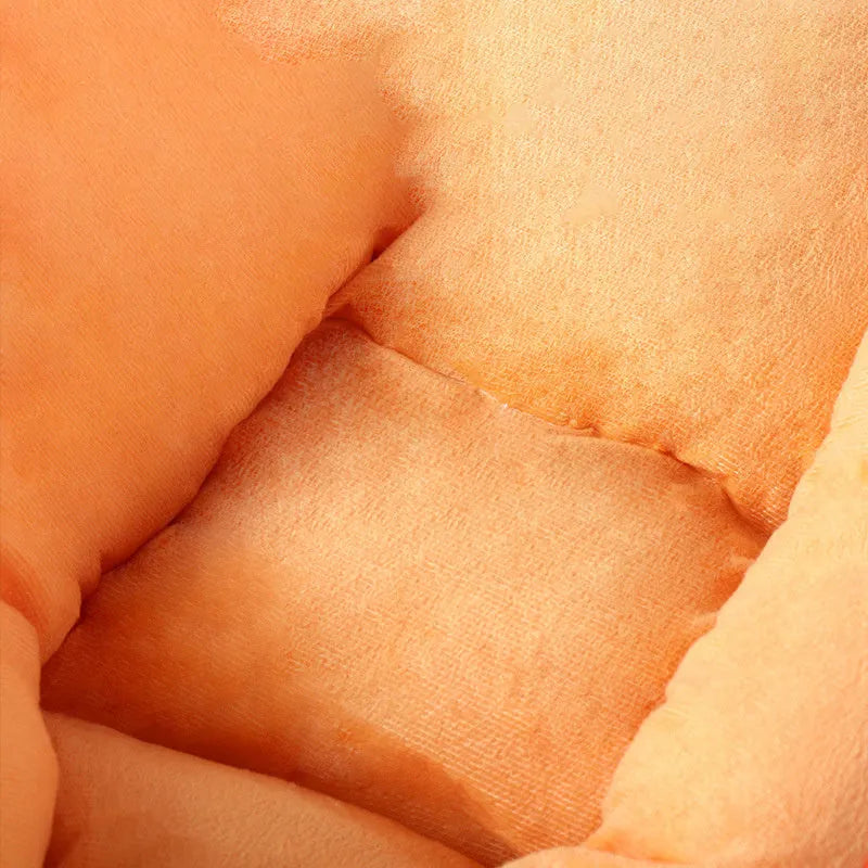 Carrot-shaped dog nesting bed with a soft, light-coloured blanket inside, suitable for a small dog.