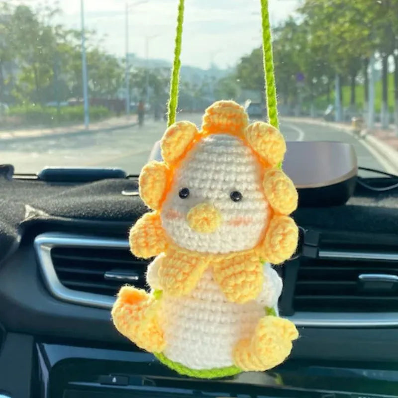 Green and white knitted wool car plant decoration with 8cm base and hanging rope.