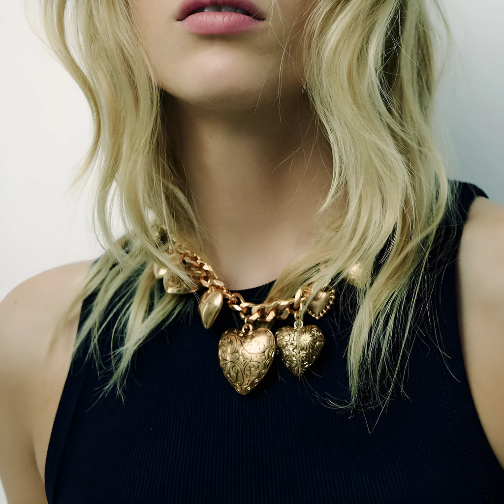 Close-up of a women's exaggerated carved heart pendant necklace on an adjustable metal chain.