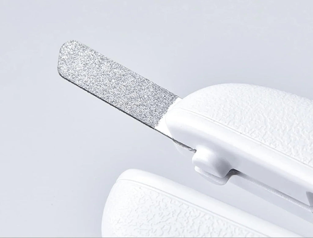 White pet nail clippers with LED light on the handle and a clear anti-splash guard covering the blades.