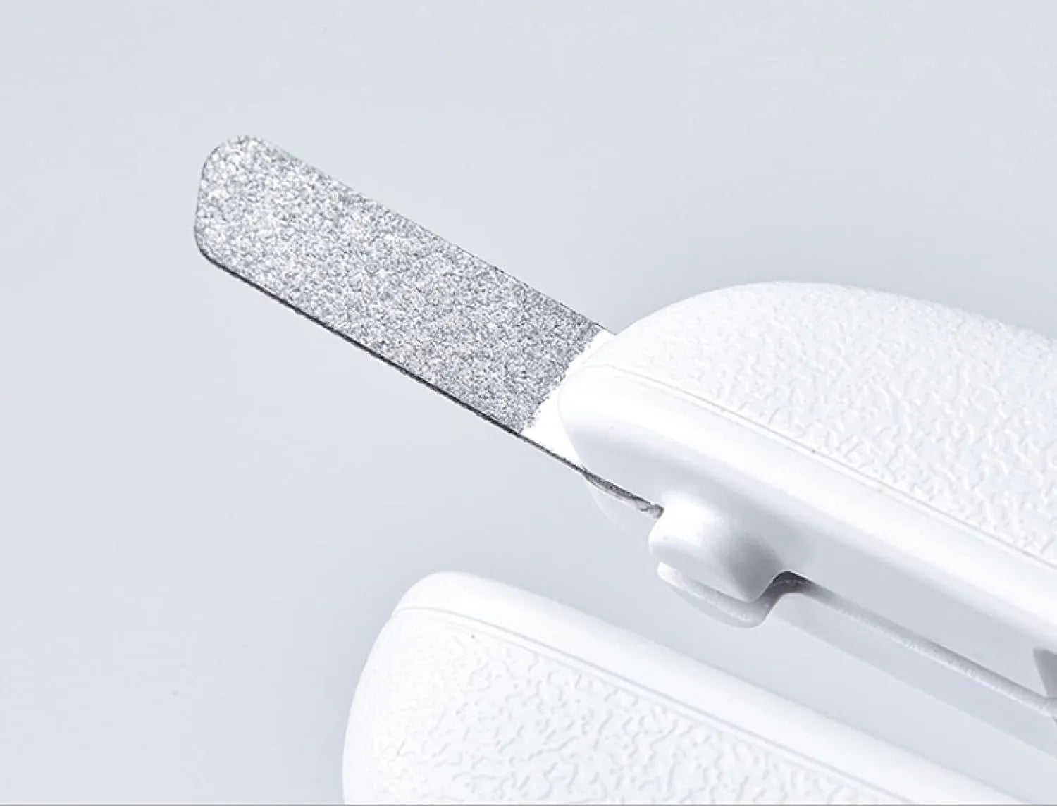 White pet nail clippers with LED light on the handle and a clear anti-splash guard covering the blades.