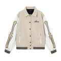 Women's apricot embroidered wool jacket with bone design detail on front.