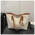 Soft PU leather ladies' shoulder bag in black showing contrast stitching and a top handle.