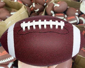 Machine sewn PU children's training American football in brown, shown with stitched seams and pointed ends for practice play