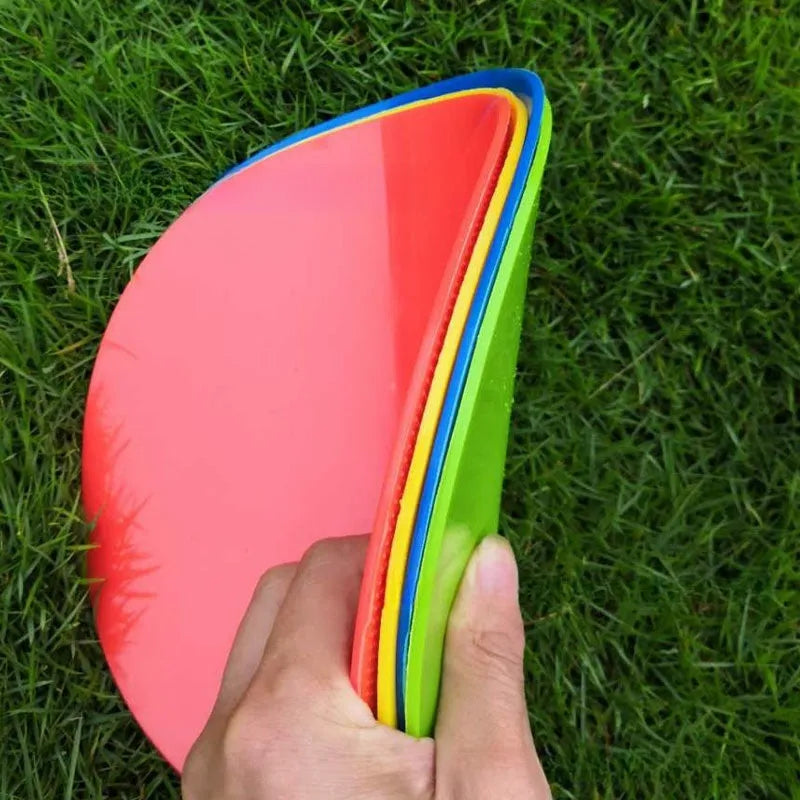 Multi-colour 23 cm diameter soft TPE football training target disc on grass