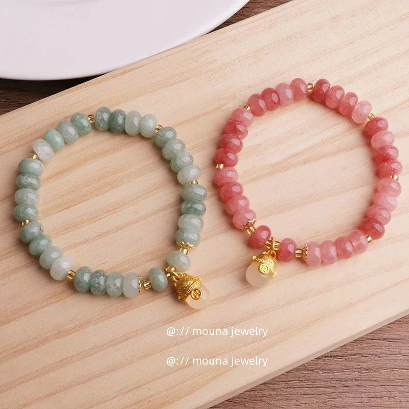 Women's strawberry quartz bracelet with a retro lucky cat charm in grey jade.
