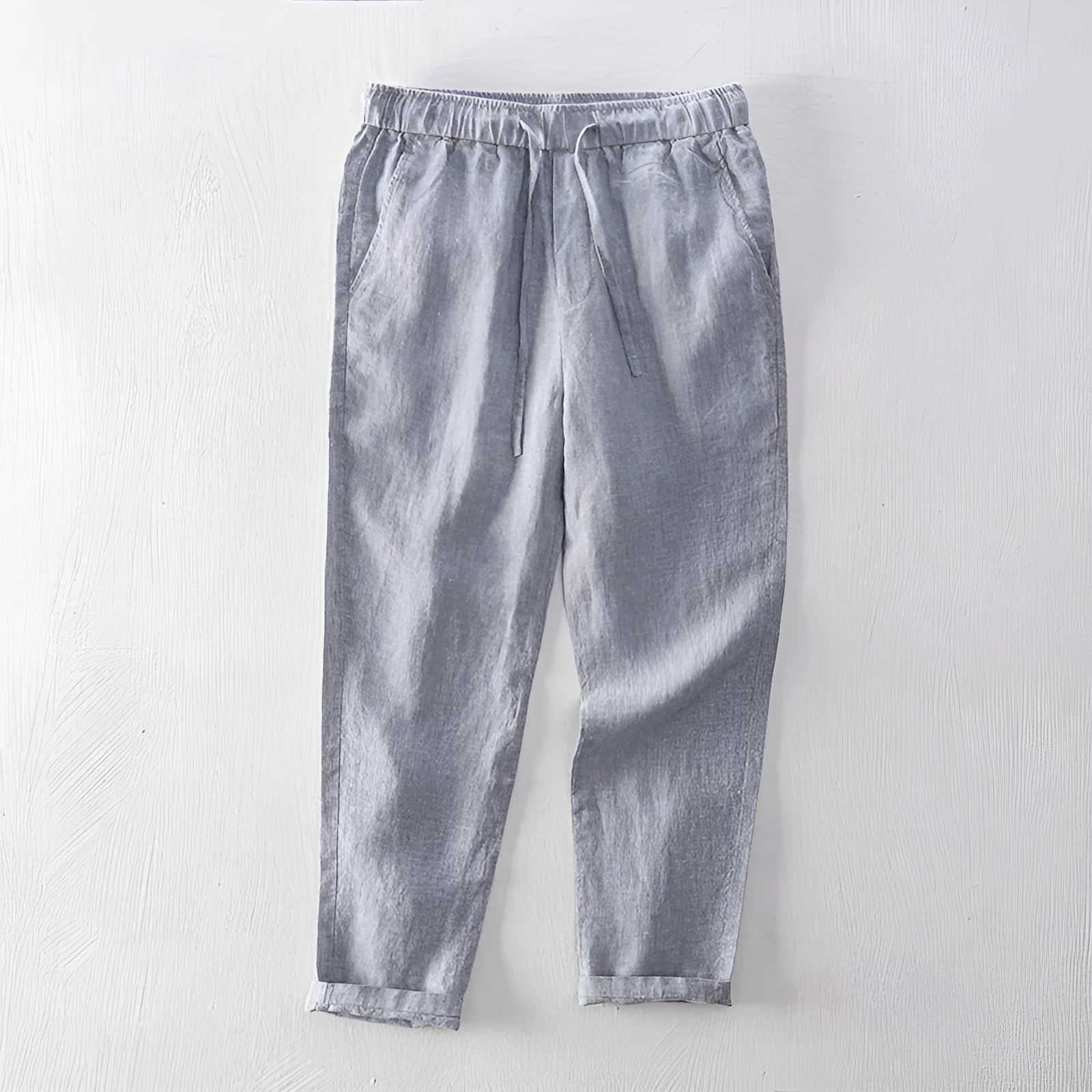 Men's linen straight leg trousers in light grey showing mid-waist design and straight cut