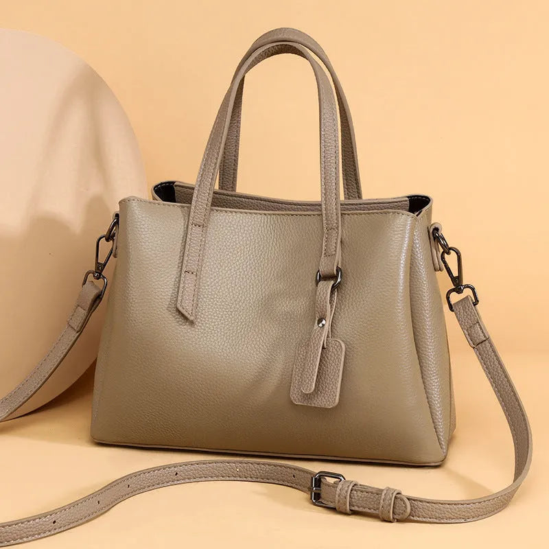 Women's cowhide leather shoulder handbag in horizontal square design with internal compartments