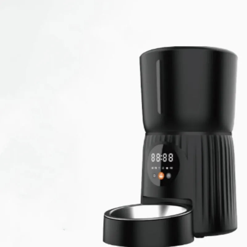 Black automatic pet feeder with smartphone showing feeding schedule and portion control settings