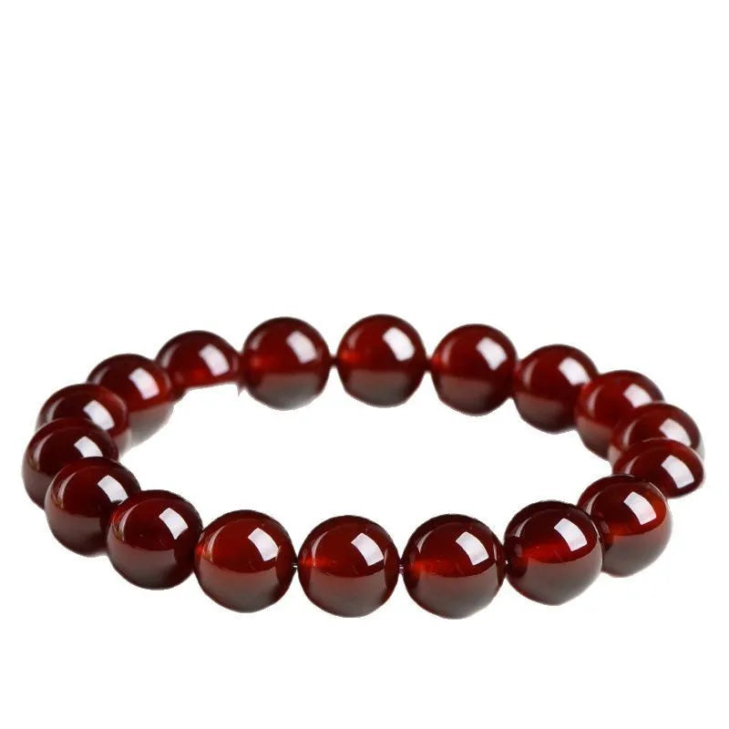 Orange red garnet crystal ball bracelet with retro ruyi design on a wrist