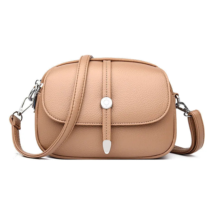 Soft PU oval-shaped women's crossbody shoulder bag in dark brown with sewing thread details.