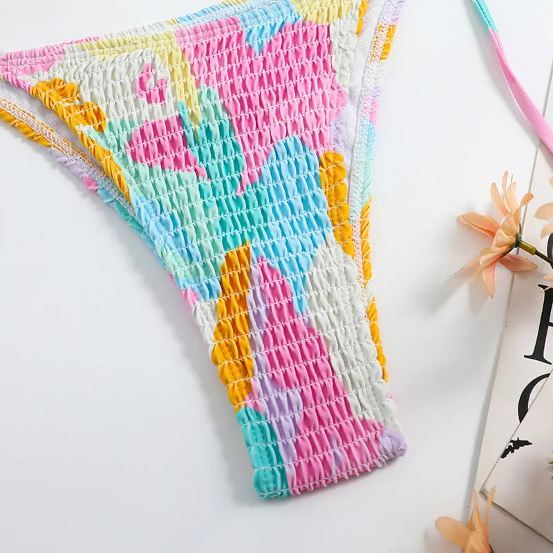 Women's multicolour floral triangle bag bikini swimsuit with split printed design and smocking craft detail.