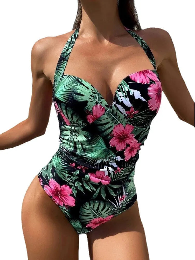 Woman wearing a printed halter-neck one-piece swimsuit with a backless design.