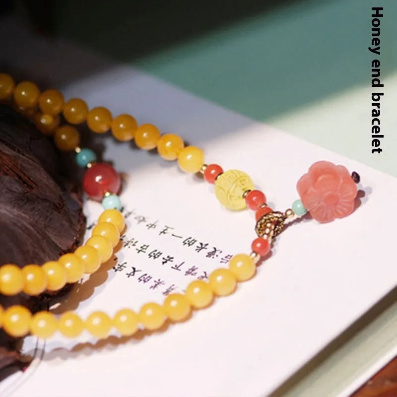 Yellow chicken grease beeswax amber bracelet with animal zodiac design in retro style