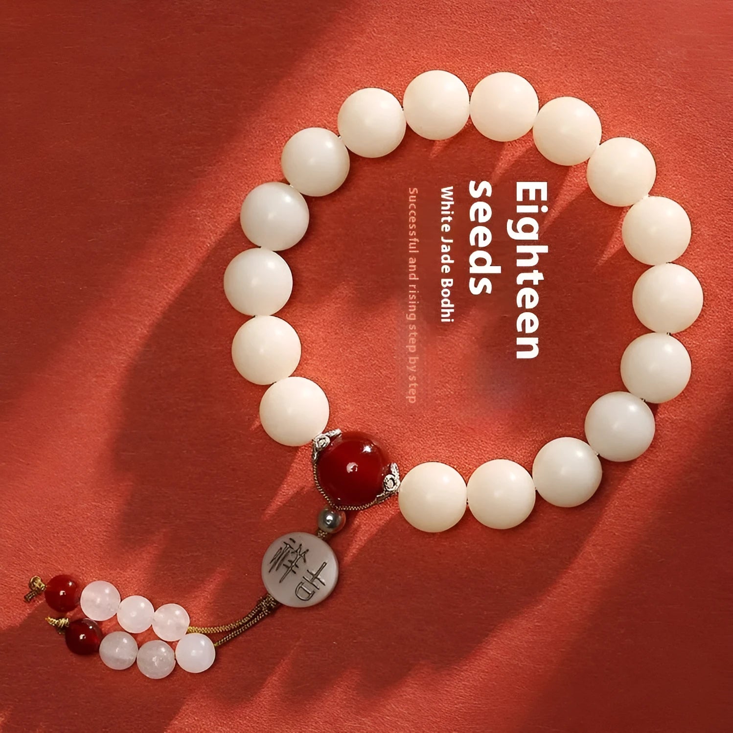White jade Bodhi bracelet with round 10mm beads, ruyi decoration, shown in obsidian, red agate and red code brain colour variants