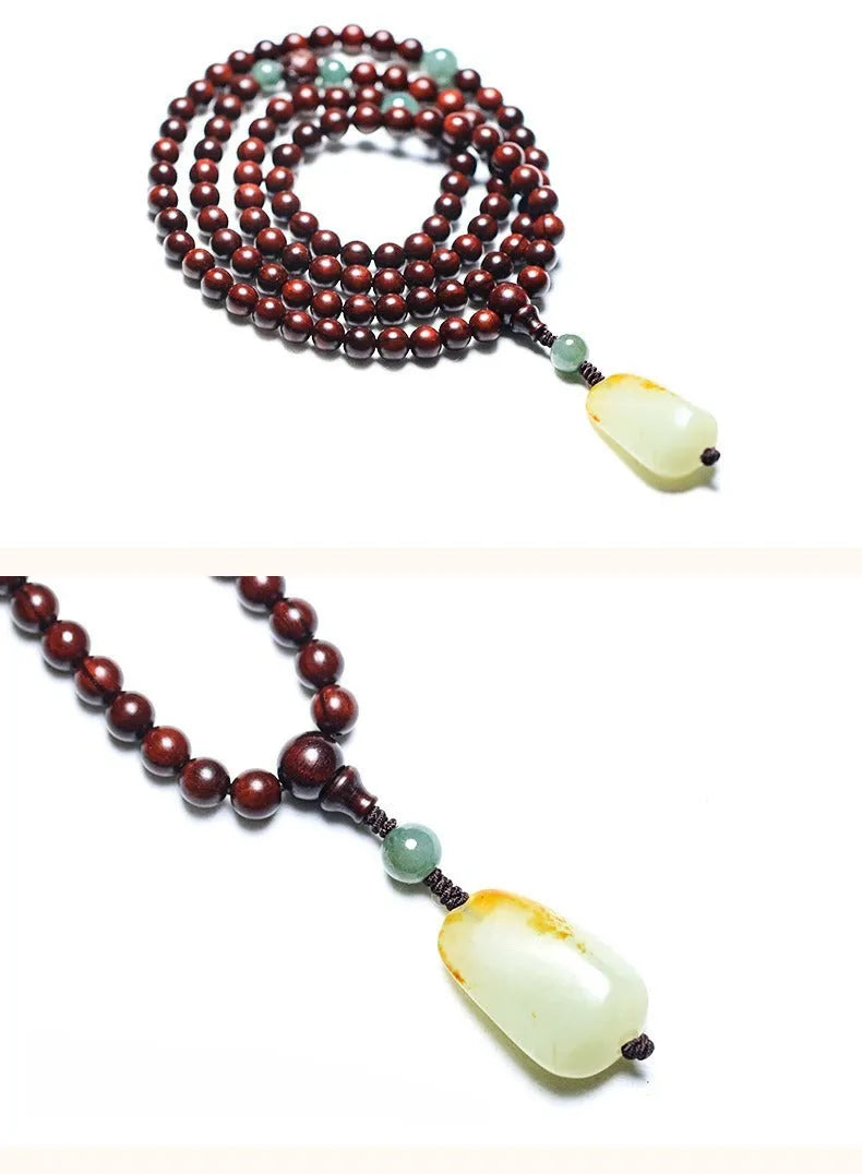 Rosewood beaded bracelet with carved wood elements and green Hotian jade pendant on wrist