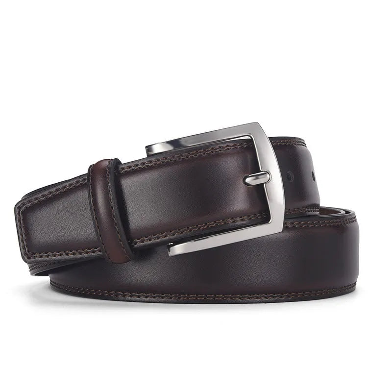 Men's black genuine leather belt with silver alloy pin buckle on a flat surface