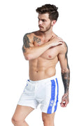 Blue men's sports shorts with lace-up front and slim fit on a white background.
