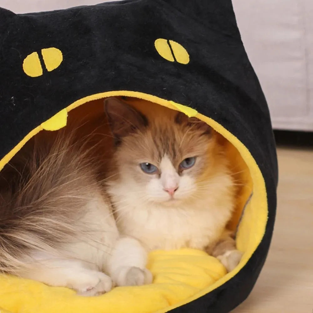 Enclosed cat-shaped pet bed with plush fabric and covered cave design
