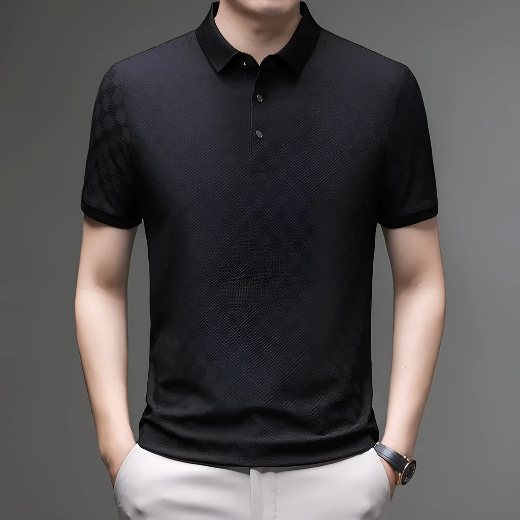 Man wearing a black rhombus-patterned short sleeve T-shirt with a slit detail.