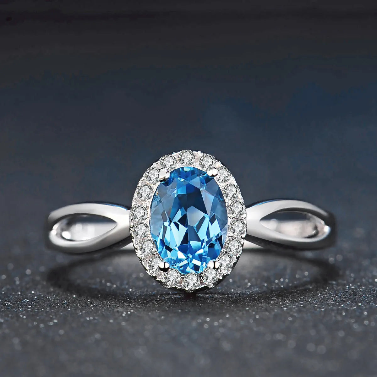 925 sterling silver four-piece jewellery set with blue topaz gems showing geometric-designed earrings, ring, pendant, and necklace