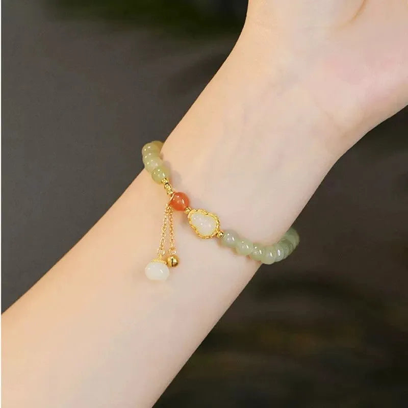 Qingshui jade bracelet with gold plated gourd charm and fu character pendant on adjustable cord