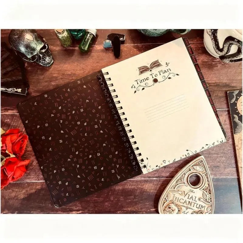 Wait For The Night 2026 weeks plan notepad with 100 pages, open to a weekly layout, next to a pen on a desk.