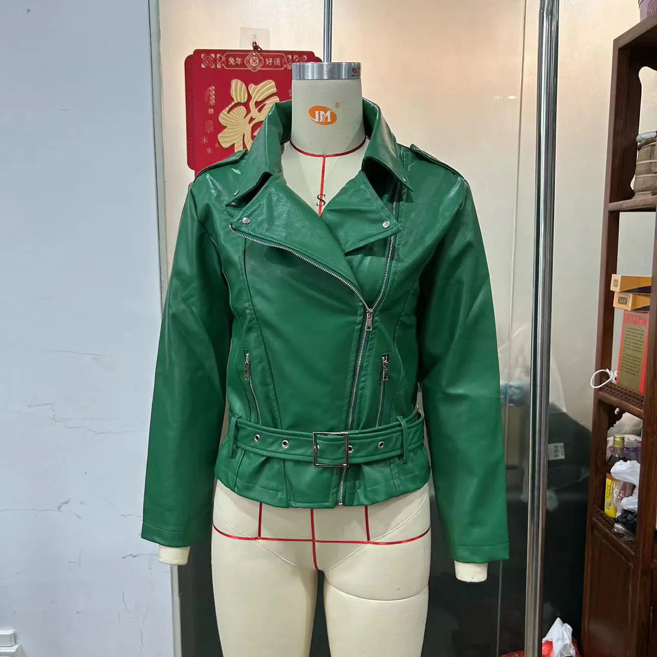 Punk short black jacket with lapel, belt, and Peter Pan collar on a model.