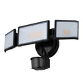 White outdoor LED security flood light with motion sensor mounted on a wall.