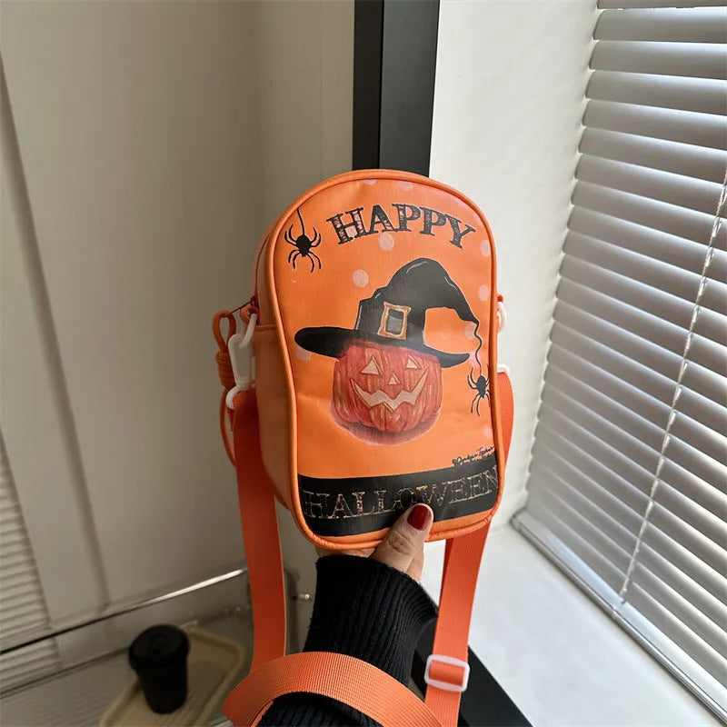 Black Halloween crossbody bag with cartoon pumpkin, ghost, and bat print, showing front and strap.
