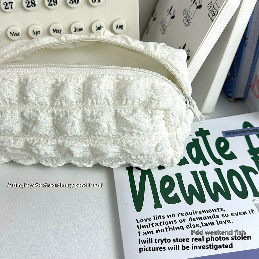 Cream puff design fabric pencil case in beige or black colour made from polyester material