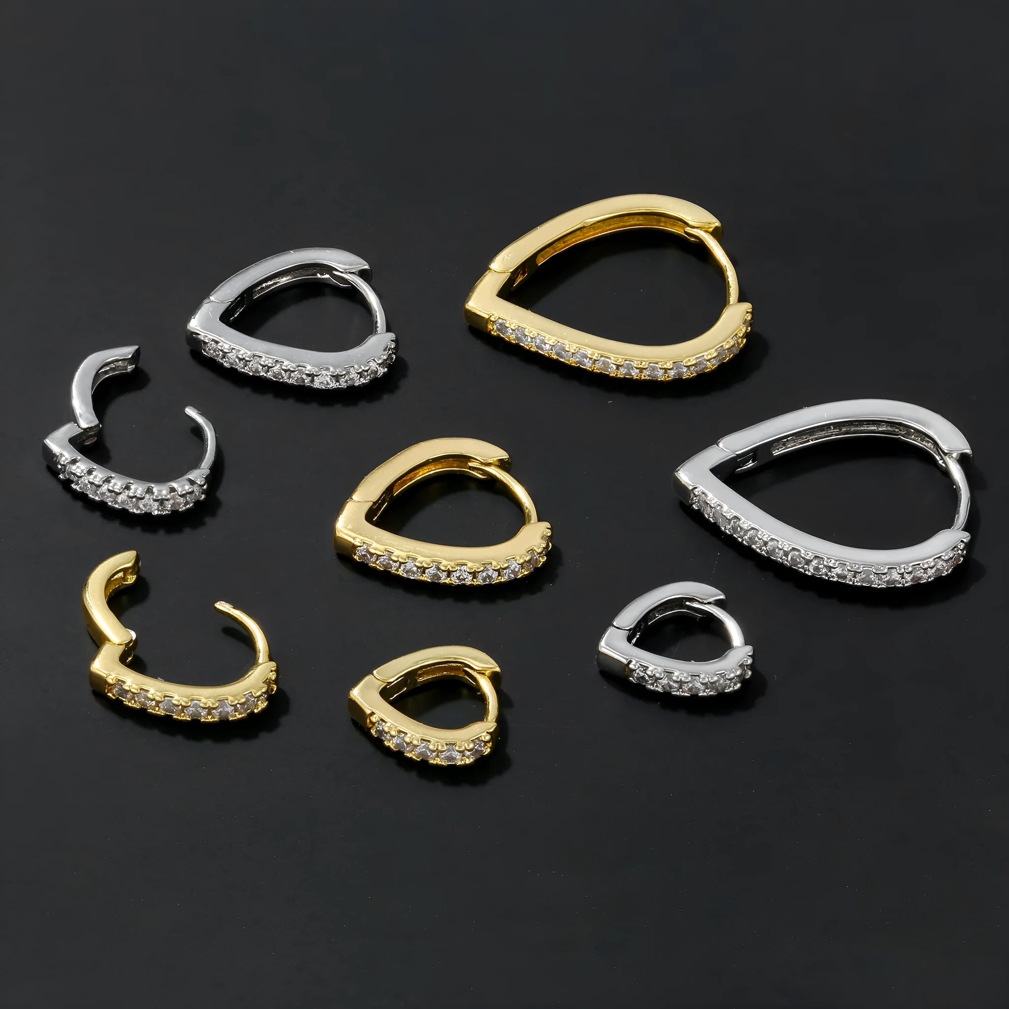 Geometric gold-coloured heart-shaped ear clip on a white background.