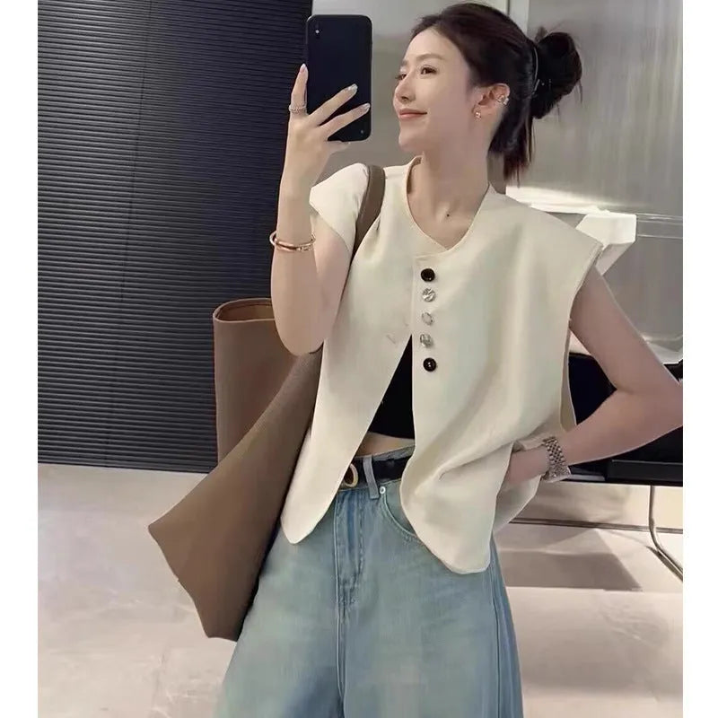 Women's loose fit solid colour polyester vest with pockets in milk white.