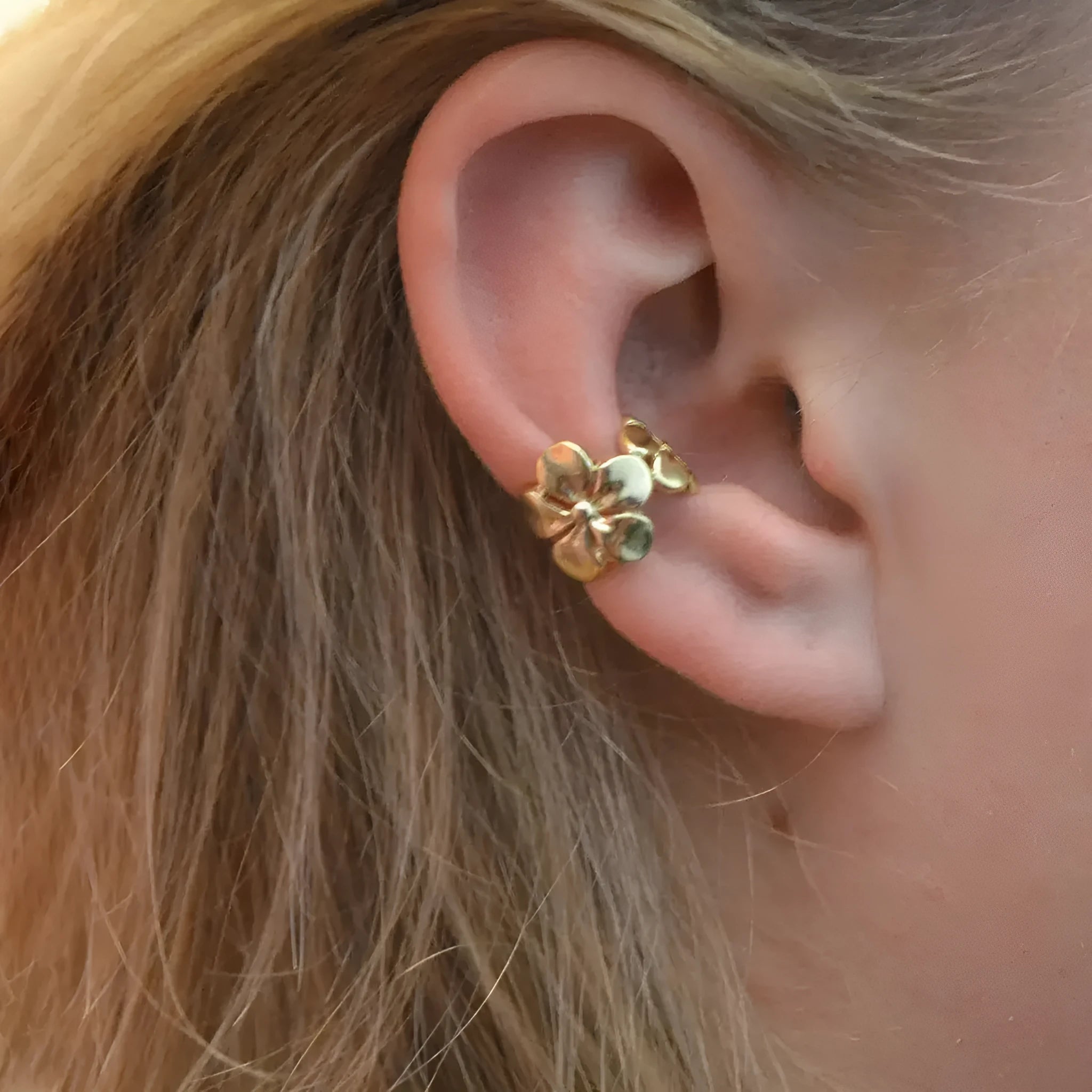 Gold electroplated alloy earrings with starfish and conch designs for women.