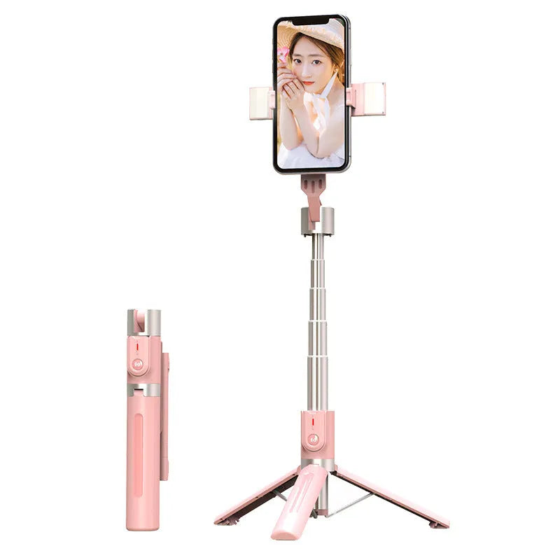Black aluminium Bluetooth selfie stick with dual fill lights extended on a desktop.