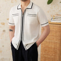 Slim black elastic lapel polo shirt on a hanger, showing short sleeves and knit texture.