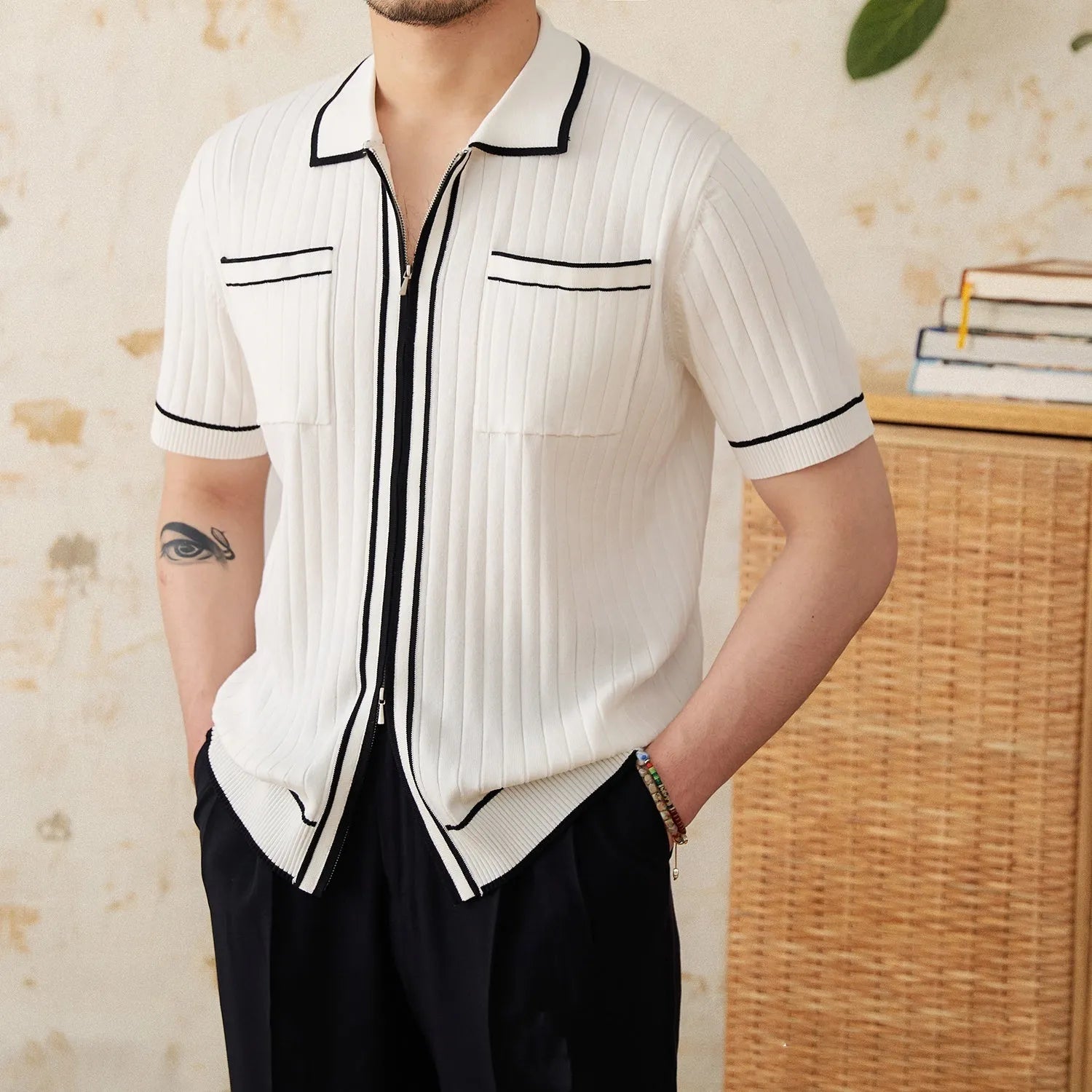 Slim black elastic lapel polo shirt on a hanger, showing short sleeves and knit texture.