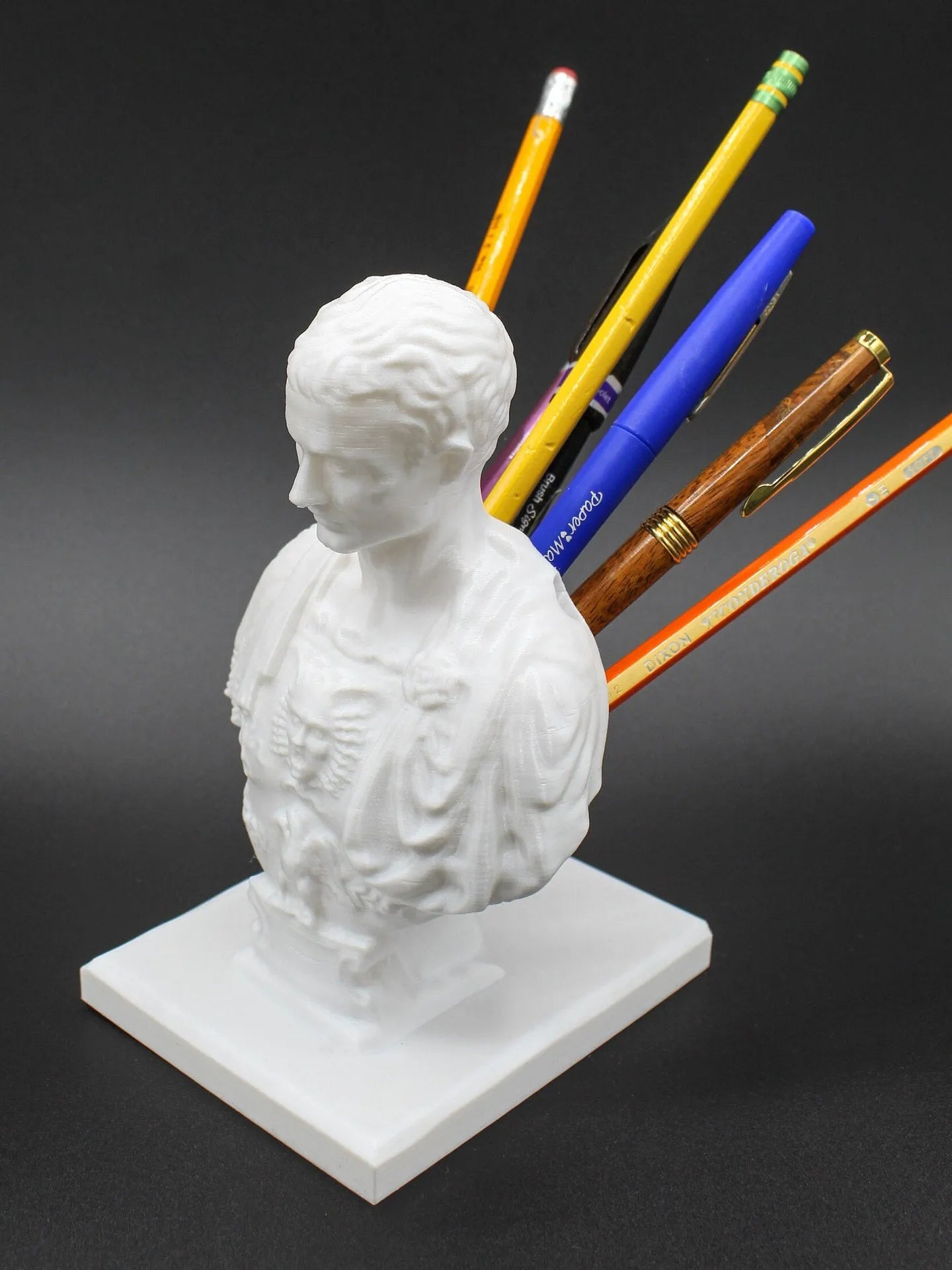 White synthetic resin American character modelling pen holder on a desk