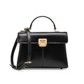 Black leather women's shoulder bag with vachette clasp, shown open to reveal internal zippered pocket.