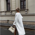 White long knitted cardigan jacket with loose fit and extended length