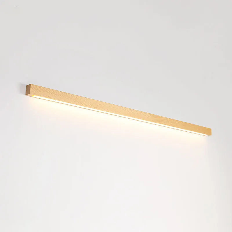 Modern Walnut wood and acrylic log strip wall lamp mounted on a wall in a living room setting.