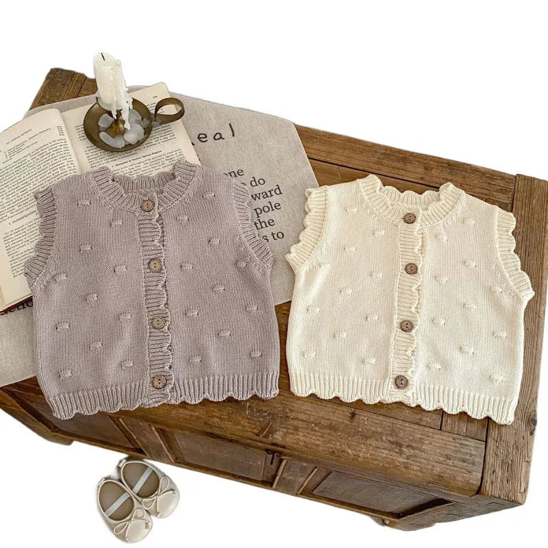 Children's knitted polka dot vest in apricot with single-breasted closure, featuring a sleeveless design for spring and autumn