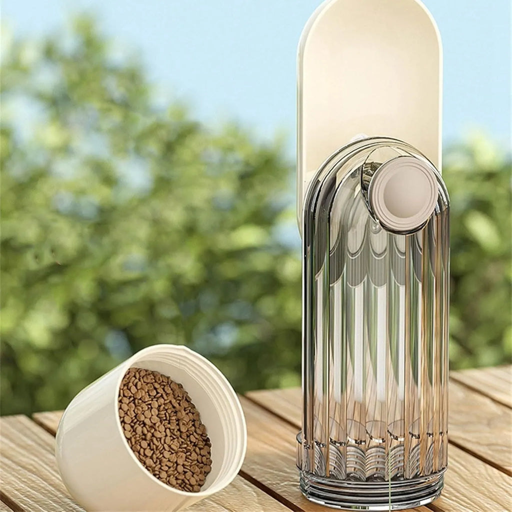 Beige collapsible dog water bottle with food container at base, showing press dispenser and tray.