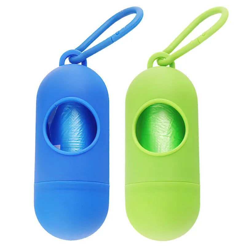 Compact black dog waste bag dispenser with a side hook and Velcro strap on its base.