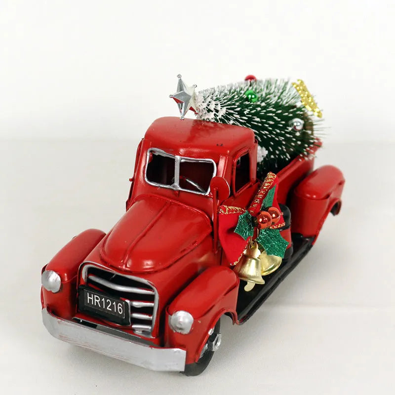 Retro red wrought iron Christmas truck ornament on a white surface, side view showing 17 cm length