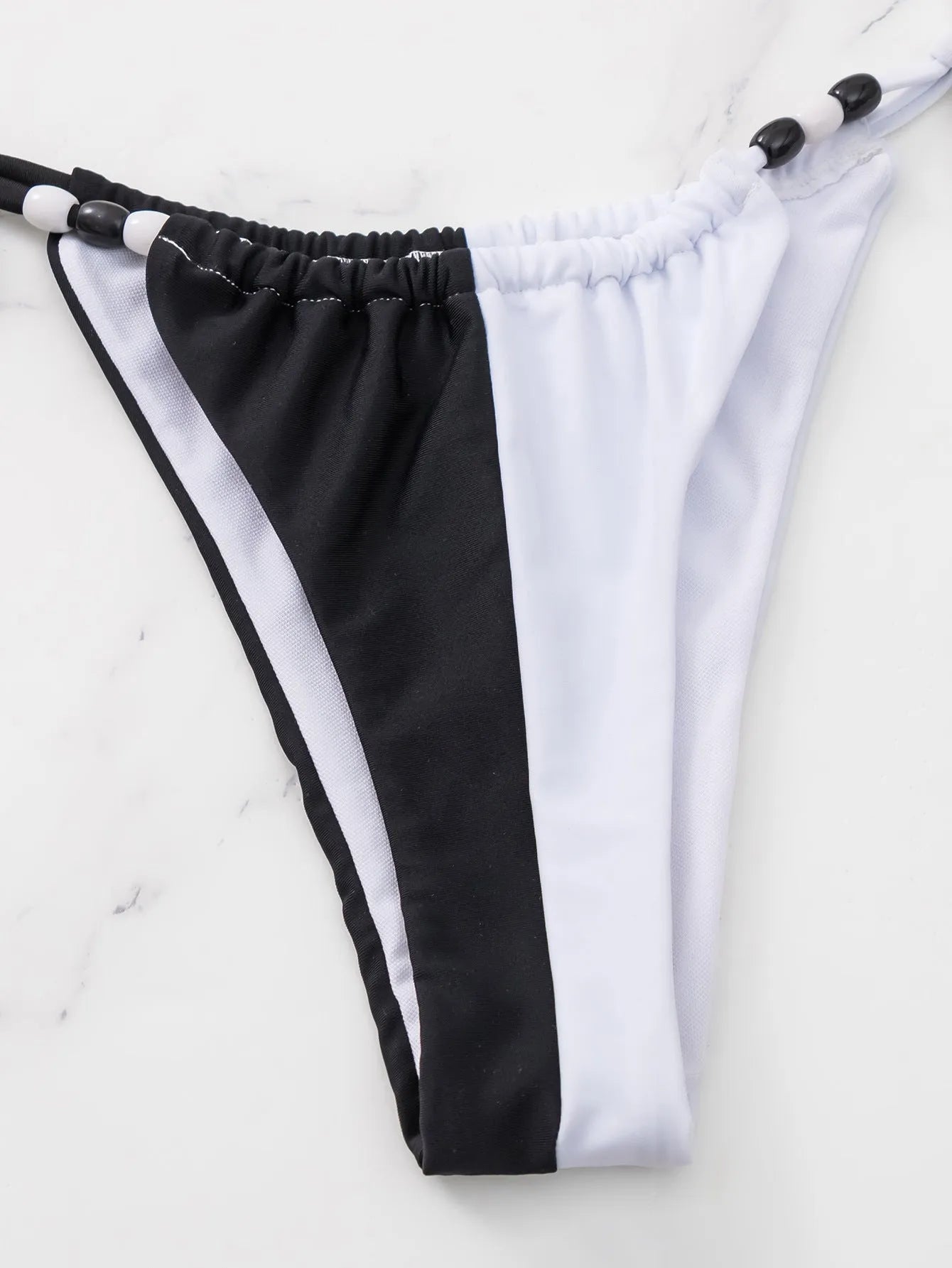 Women's black and white lace-up triangle cup bikini swimsuit with briefs-style bottoms